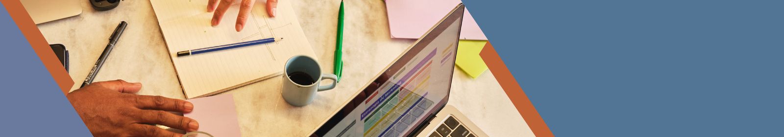 person sliding paperwork to another across a desk