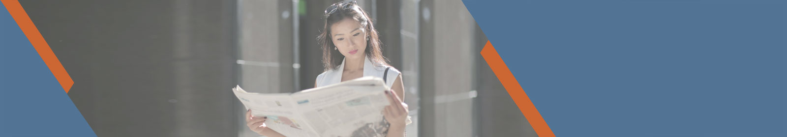 woman reading a newspaper outside